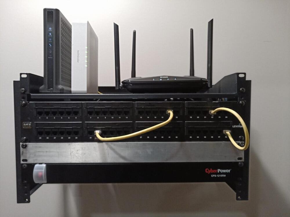 Completed home network rack with Cat6 patch panels and UPS