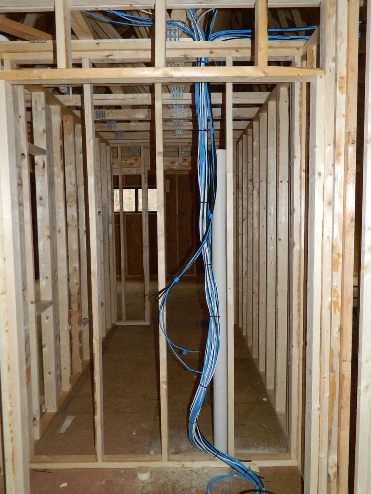Structured cabling and Cat6 network wiring rough-in during new home framing